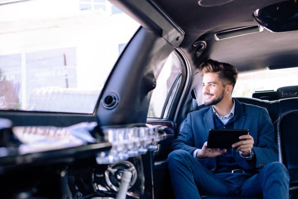 Young businessman sitting in limousine